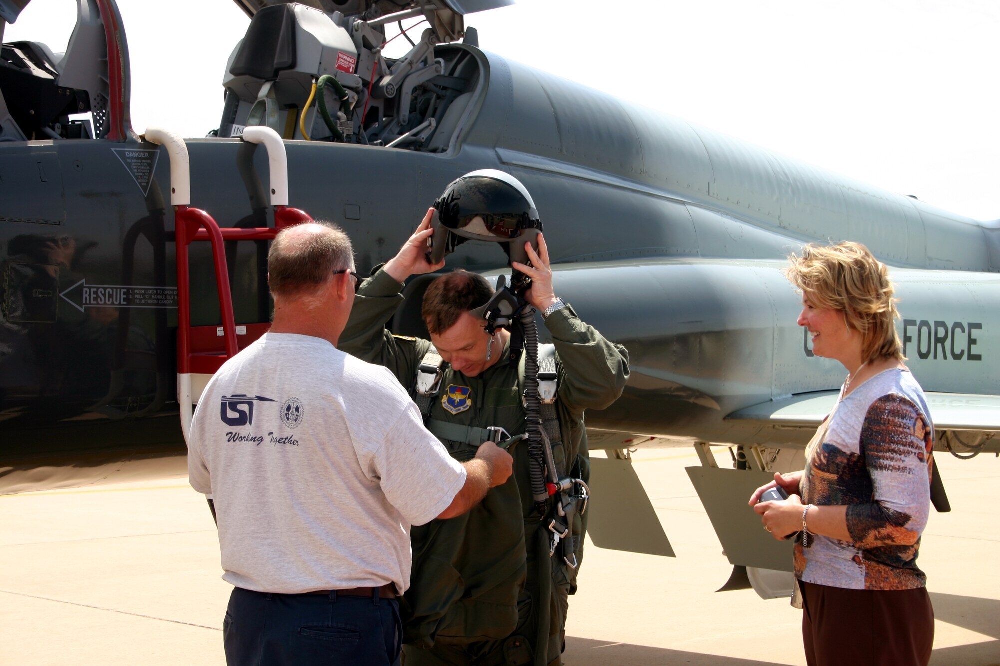 Wichita Falls city manager Darren Leiker, fresh from his orientation flight sponsored by the 90th Flying Training Squadron, removes his gear while wife Beth looks on. (U.S. Air Force photo/Staff Sgt. Tonnette Thompson)