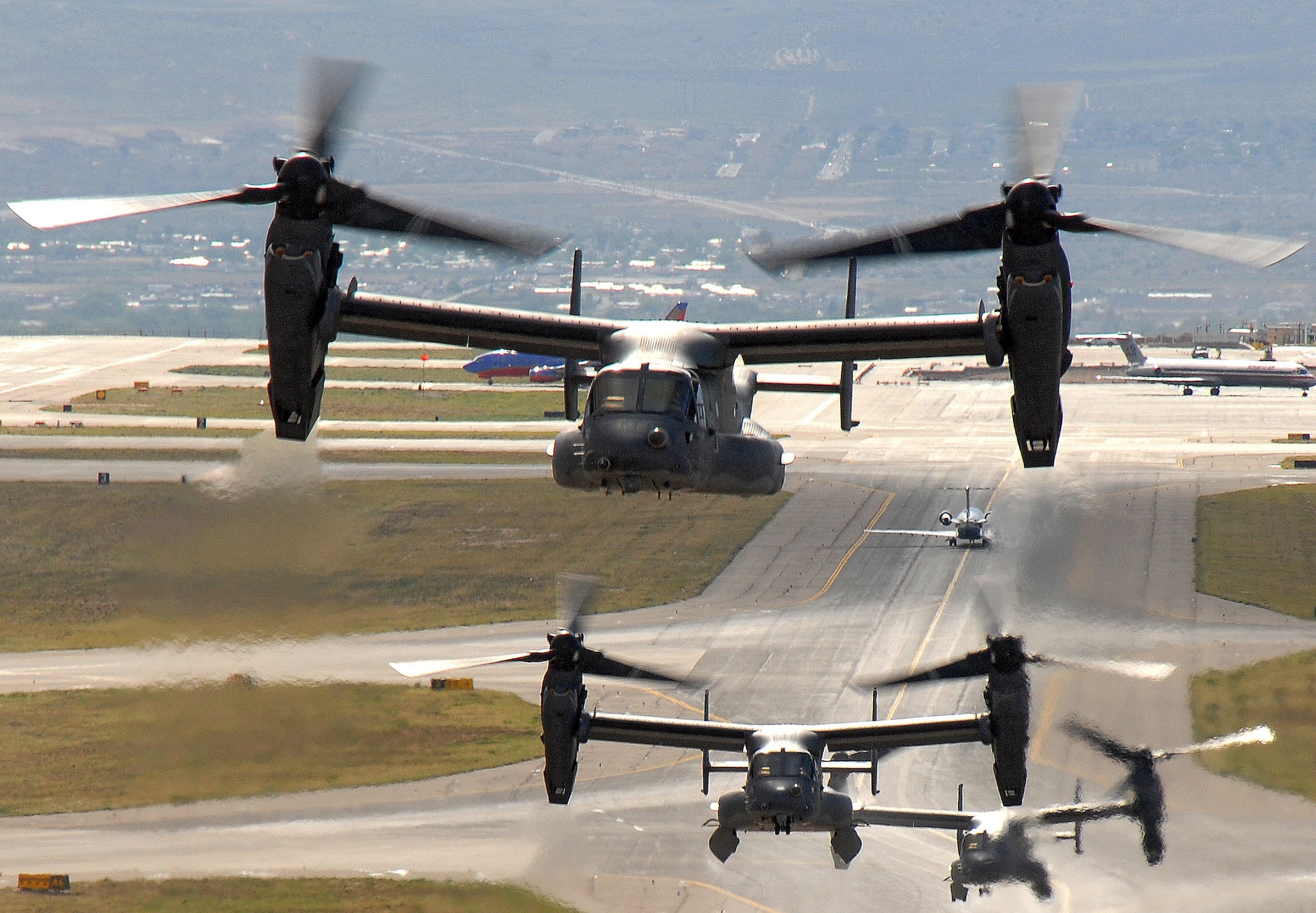 Air Force CV-22 Ospreys take off from a Kirtland Air Force Base, N.M. May 1 for a training mission.  The Osprey is a tiltrotor aircraft that combines vertical takeoff, hover and landing qualities of a helicopter with the normal flight characteristics of a turboprop aircraft.  (U.S. Air Force photo/Staff Sgt. Markus Maier)