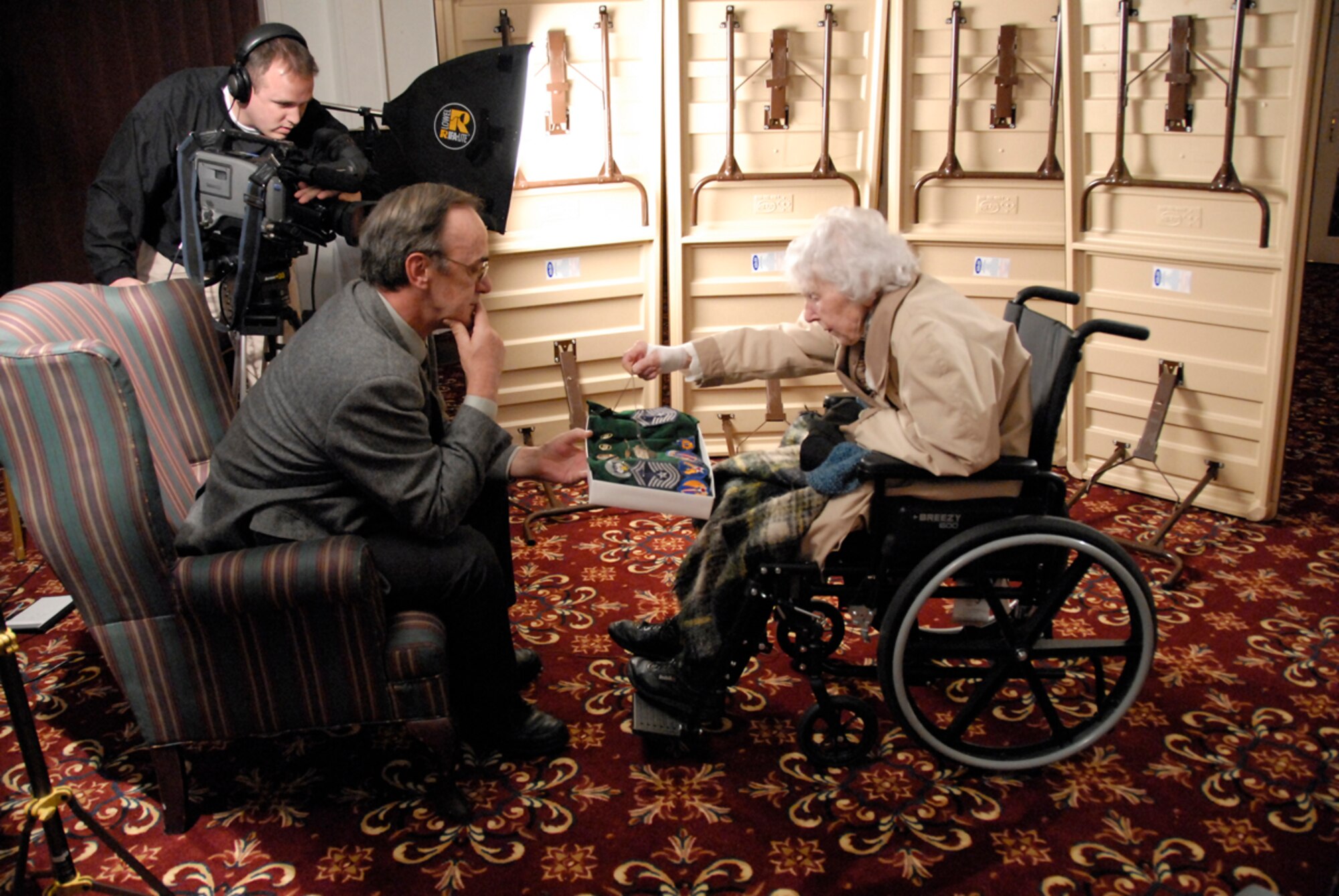 Right, Retired Chief Master Sgt. Esther MacKay, 101, explains where and when she received her various military memorabilia to J.C. Corcoran during an interview for Hanscom's Living History Project. The documentary will highlight servicemember and their families contributions to the Air Force over the past 60 years in celebration of the AF's 60th anniversary. (U.S. Air Force photo by 1st Lt. Martha Petersante-Gioia)