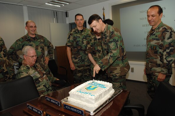 Col. Earl Matthews, 435th Air Base Wing commander, cuts a birthday cake for the wing. The wing turns 58 this year. Photo by Senior Airman Levi Riendeau.