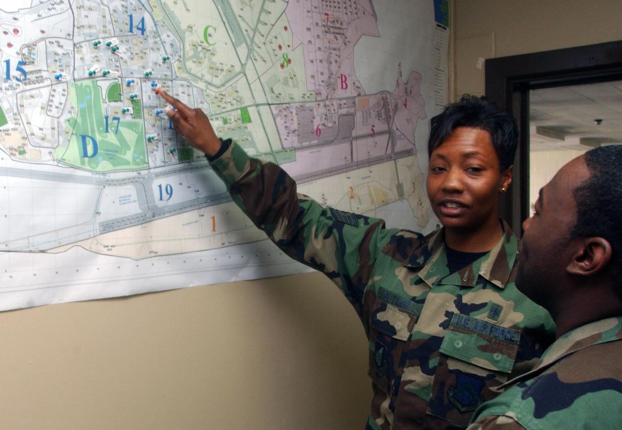 Tech. Sgt. Dana Butler, First-Term Airman Center non-commissioned officer in-charge, shows co-worker Staff Sgt. Andrew Baines key locations around Kunsan May 17. She was selected as the 8th Fighter Wing's Pride of the Pack for the week of May 21. (U.S. Air Force photo/Senior Airman Steven Doty) 