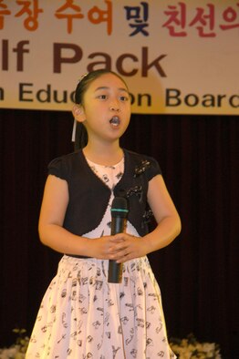 GUNSAN CITY, Republic of Korea  May 17, 2007 -- Miss Yi, Ester, a second-grade student from the Gunsan Busol elementary school, sings a Korean song, entitled 'To The Sky,' to English volunteers and honored guests May 16 during the 2007 English volunteer recognition dinner. 55 members of the 8th Fighter Wing "Wolf Pack" were recognized by the local education board for their dedication in helping to teach English to elementary and middle school students. (U.S. Air Force photo/Senior Airman Stephen Collier)  