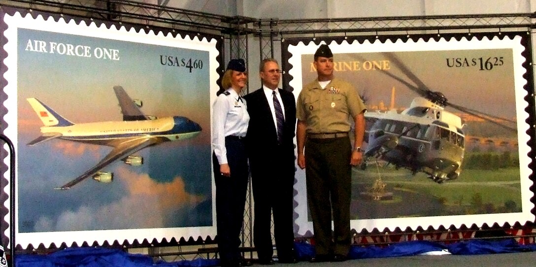 Left to right: Air Force Col. Margaret H. Woodward, commander of the 89th Airlift Wing; David Failor, the U.S. Postal Service’s executive director of stamp services; and Marine Col. Andrew W. O’Donnell Jr., commander of Marine Helicopter Squadron One, participate in a May 18 ceremony that kicked off this year’s Joint Services Open House and previewed new postage stamps commemorating Air Force One and Marine One at Andrews Air Force Base, Md. Photo by Gerry J. Gilmore