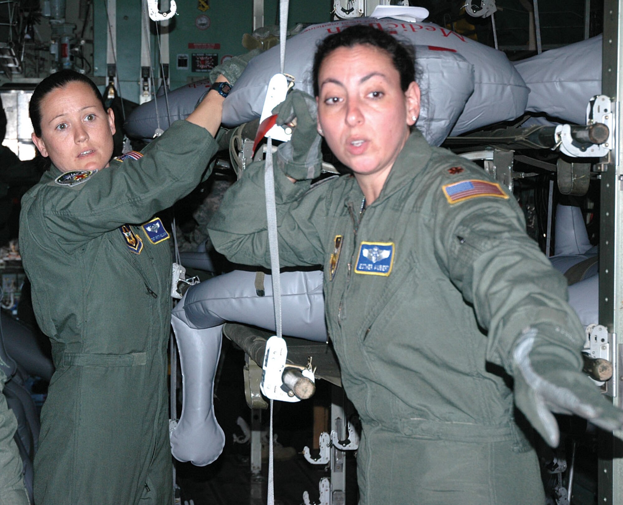 Tech. Sgt. Kristy Wellman, left, and Maj. Easter Aubert, work a plan of action to off load simulated patients from an Alaska Air National Guard C-130 after it landed at McChord Air Force Base, Wash., May 10. The air evacuation of patients from Alaska was one element of the training exercise Alaska Shield/Northern Edge, Alaska's portion of an annual national training exercise designed to hone interagency cooperation during an aeromedical evacuation exercise.  Sergeant Wellman and Major Aubert are with the Air Force Reserve's 446th Airlift Wing at McChord. (U.S. Air Force photo/Sandra Pishner)