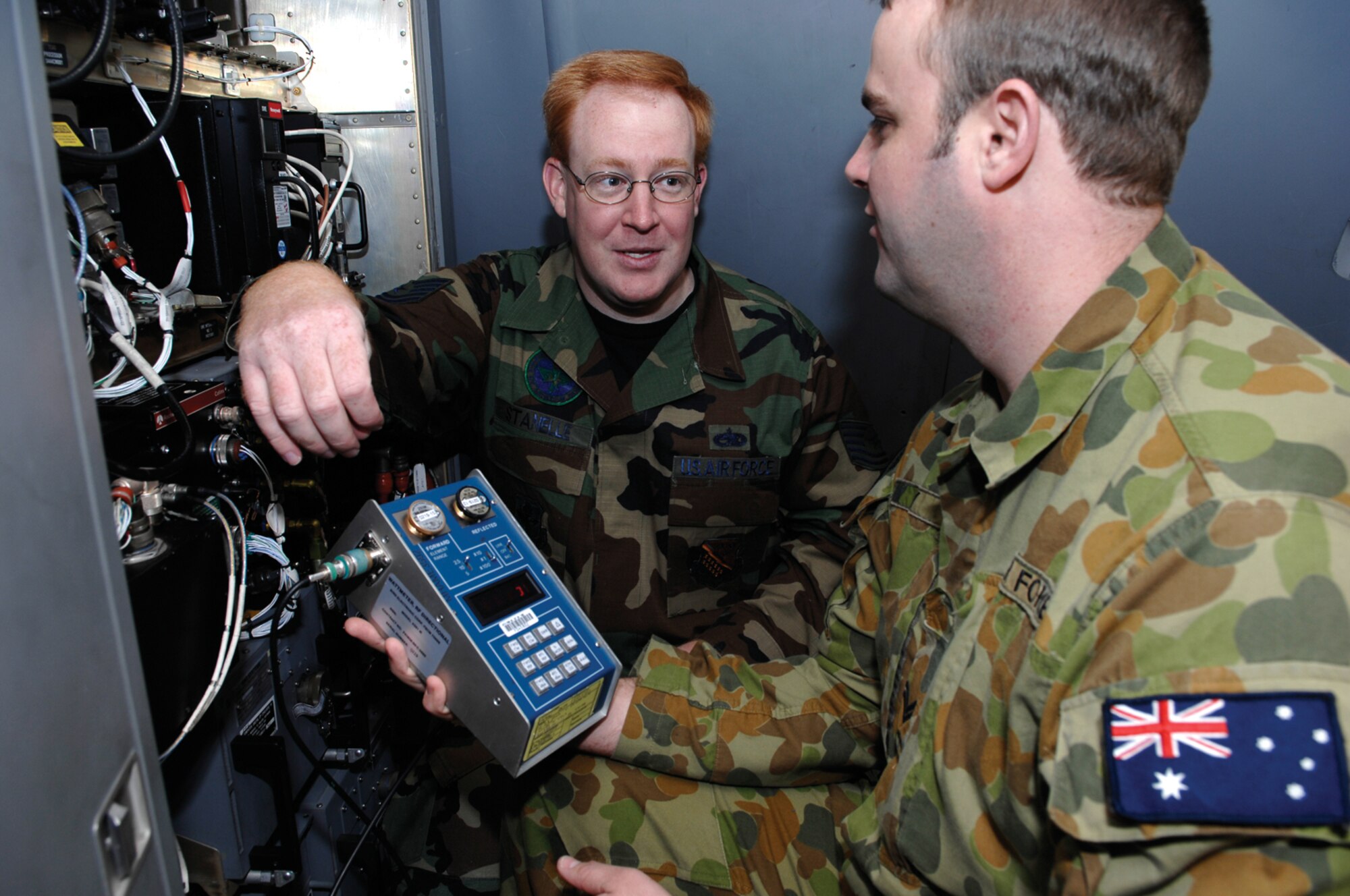 Tech. Sgt. Jason Stanelle, 373rd Training Squadron, provides maintenance instruction to an Australian airman.  Many McChord-based Airmen are playing a role in developing Australia's C-17 program, including a Reservist with the 446th Maintenance Squadron - Tech. Sgt. Jesse Strowbridge. (U.S. Air Force photo/Abner Guzman)