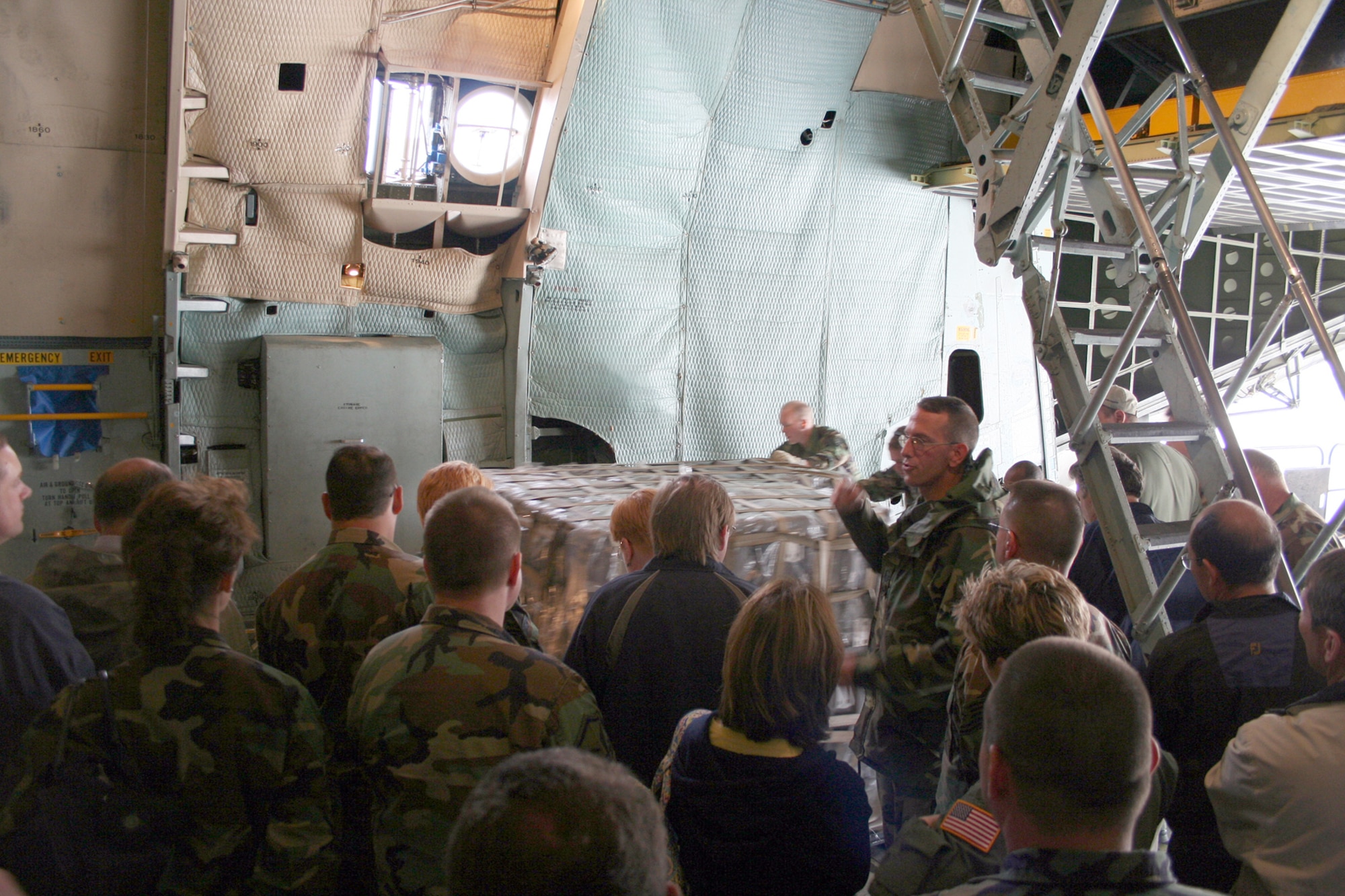 WRIGHT-PATTERSON AFB, Ohio – Master Sgt. Edward Kirker (right center) from the 87th Aerial Port Squadron explains to 40 employers with their reservists how supplies and equipment on pallets are loaded on a C-5 aircraft.  Employers visited the 445th Airlift Wing on Employers Day to learn more about what their employee does on drill weekends and when their deployed. (U.S. Air Force photo/Maj. Ted Theopolos)