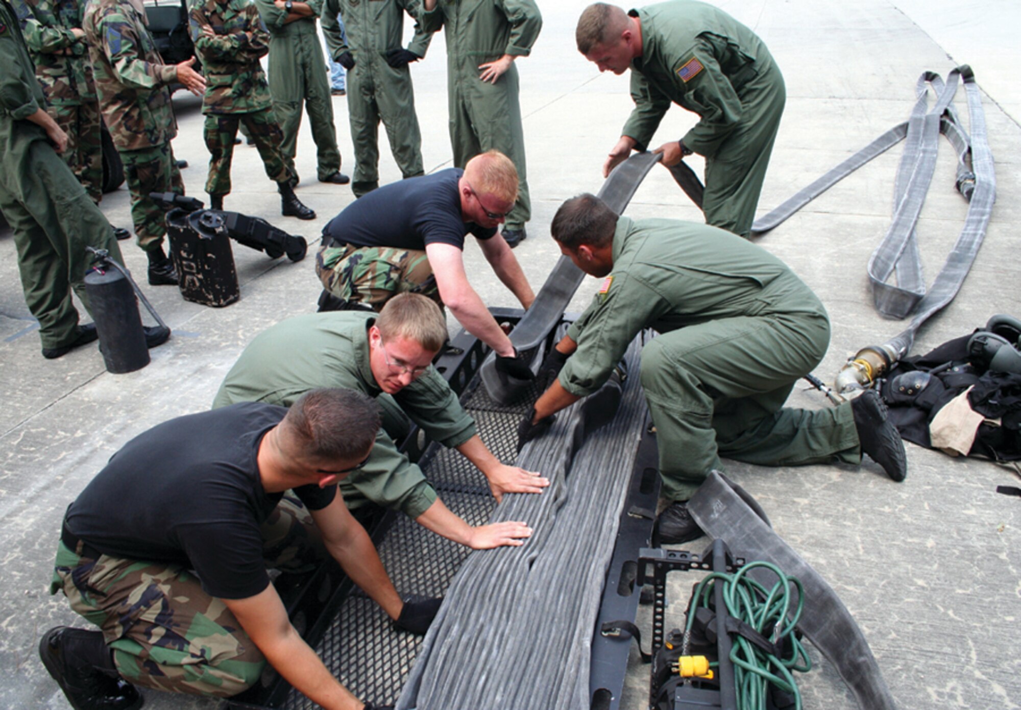 Airmen for POL store the 300 feet of hose used for the FARP pull. Chief master sergeants from the 1st Special Operations Mission Support Group were invited to participate in the FARP pull to have a better understanding of the job a single person FARP crew member must perform (U.S. Air Force photo by 2nd Lt. Jesse Brannen)