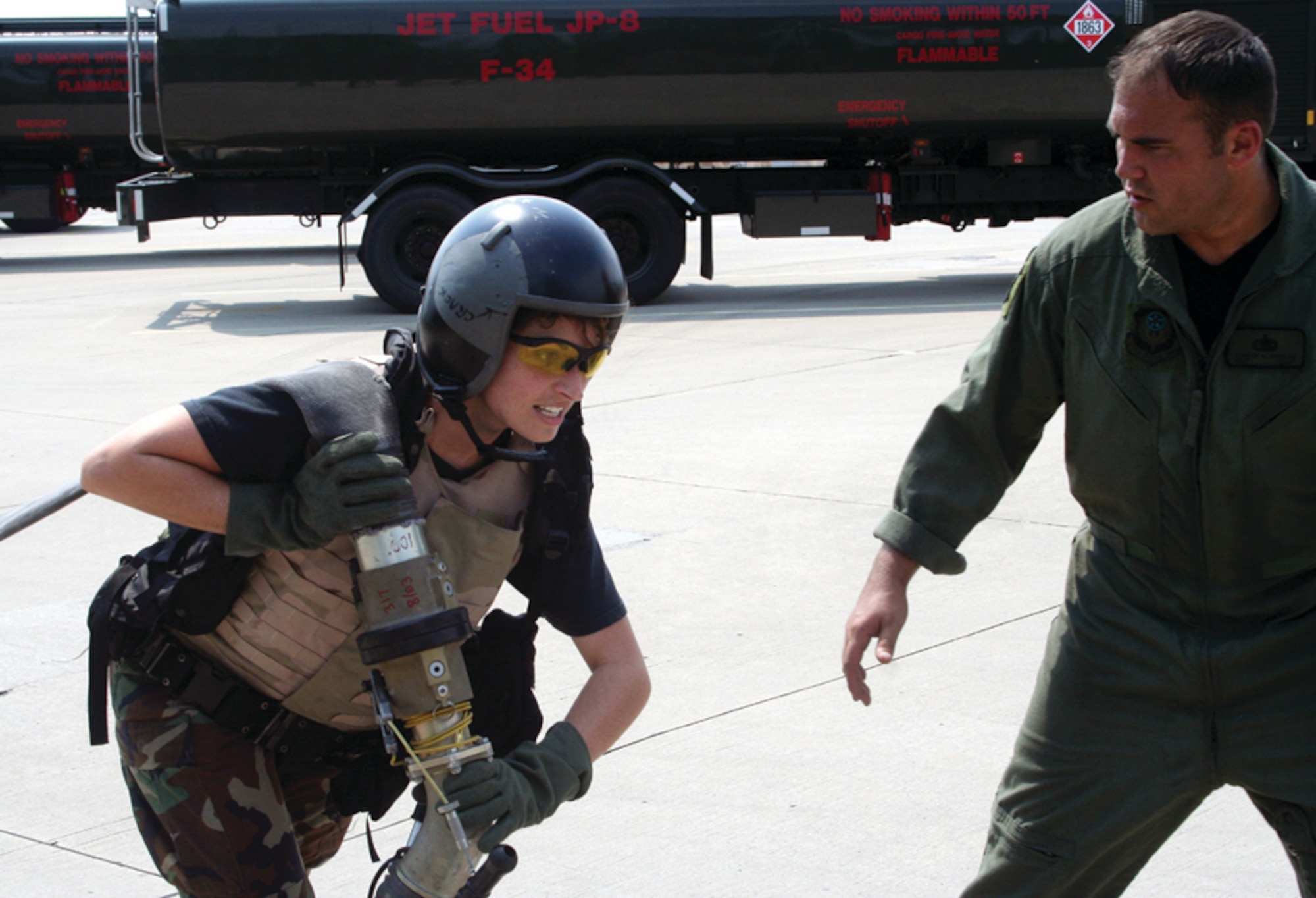 1st Lt. Shanna McCoy, who is taking over as the fuels management flight commander, is encouraged by Staff Sgt. Vernon Duncan, 1st Special operations Logistics Supply – Petroleum, Oil and Lubricants, during the Forward Air Refueling Point pull May 11. Several of Team Hurlburt’s chiefs were invited to try their hand at a mock refueling. (U.S. Air Force photo by 2nd Lt. Jesse Brannen)