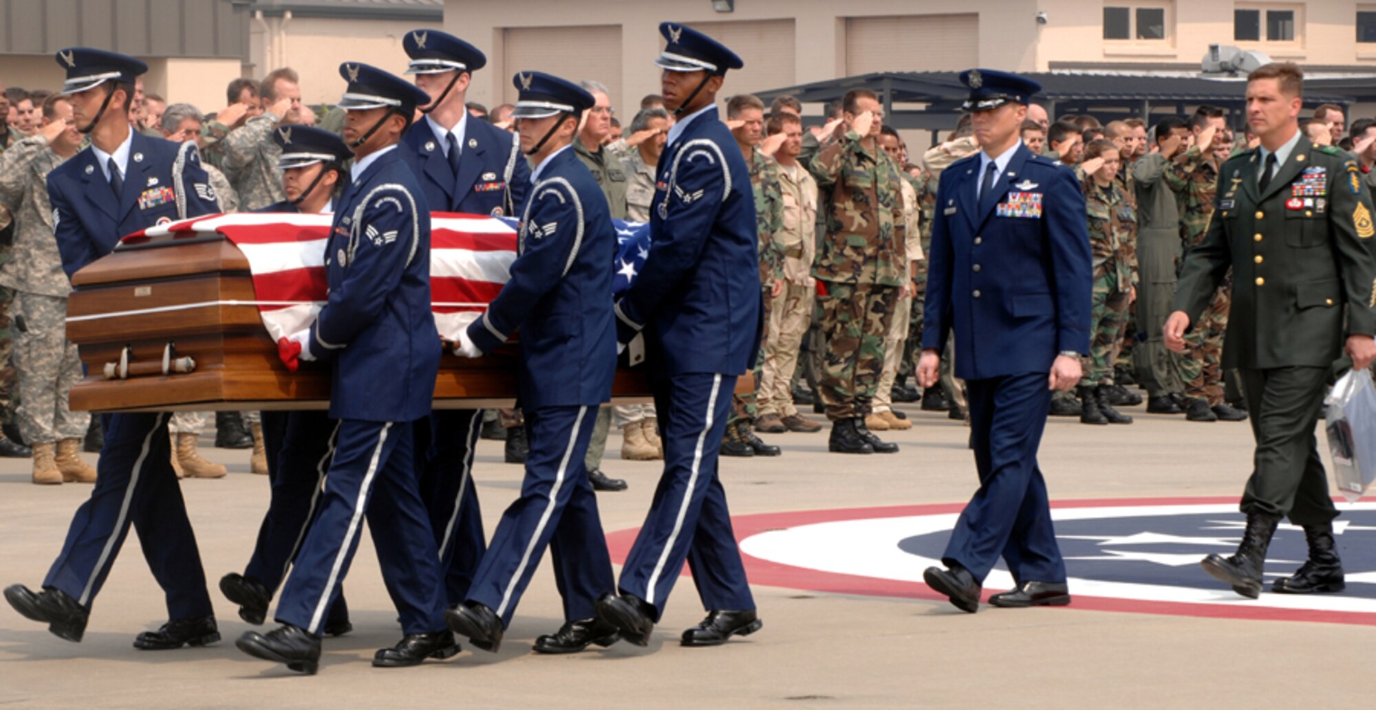 More than 800 airmen salute as the casket with Army Sergeant Padgett is carried onto the MH-53 PAVE LOW to its final destination in Defuniak Springs May 14. Team Hurlburt Airmen work side-by-side with the U.S. Army, Navy and Marines fighting the Global War in Terrorism (U.S. Air Force photo by Senior Airman Cynthia Morrow)