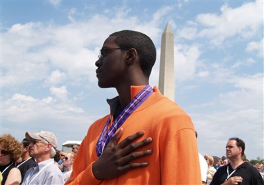 Quincy Jallah, son of a fallen soldier, honors the presentation of colors during the “Time of Remembrance” ceremony, May 20, 2007, near the Washington Monument.