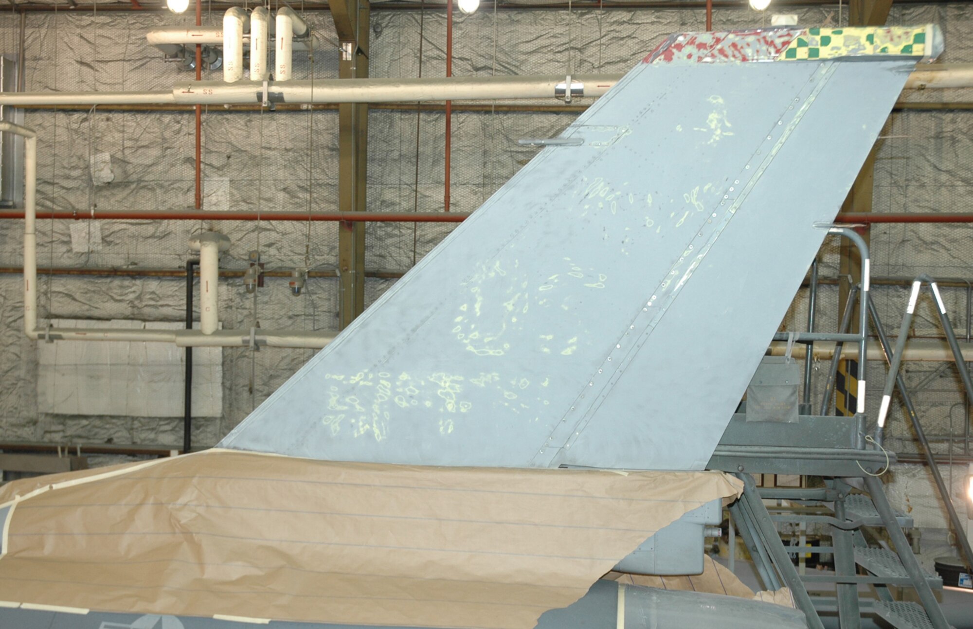 OSAN AIR BASE, Republic of Korea --  The old tailflash of Brig. Gen. Joe Reynes' F-16 Fighting Falcon has been completely removed. The tail was repainted with a Korean Conflict-era "Checkertail" design, in honor of the 51st Fighter Wing's heritage. (U.S. Air Force photo by Tech. Sgt. Michael O'Connor)