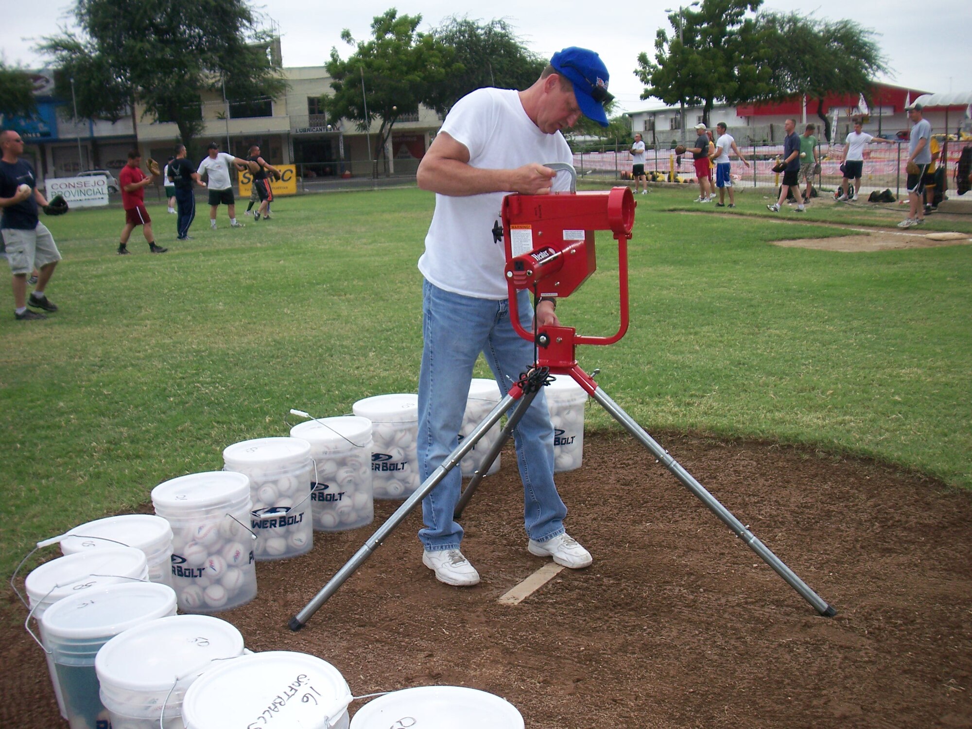 SMSgt. Tom Hren, 190th Air Refueling Wing (which is deployed as part of the 478th Expeditionary Operations Squadron), assembles a pitching machine that was donated to the Manta Baseball Academy. (Photo by Maj. Chris Hemrick)