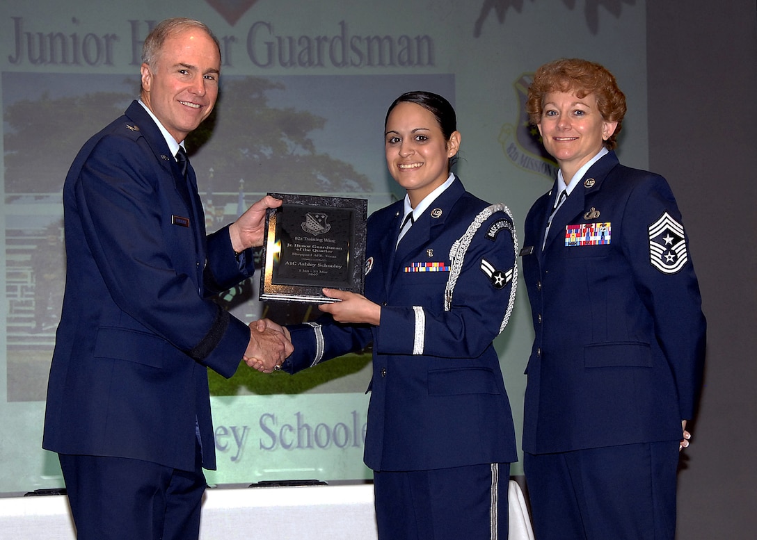 Brig. Gen. Richard Devereaux, left, 82nd Training Wing commander, presents Airman 1st Class Ashley Schooley of the 82nd Medical Operations Squadron the Junior Honor Guardsman of the Quarter award May 16 at the wing's quarterly award luncheon at the Sheppard Club. Also pictured is Chief Master Sgt. Jeannie McLean, command chief master sergeant for the 82nd TRW. (U.S. Air Force photo/Harry Tonemah)