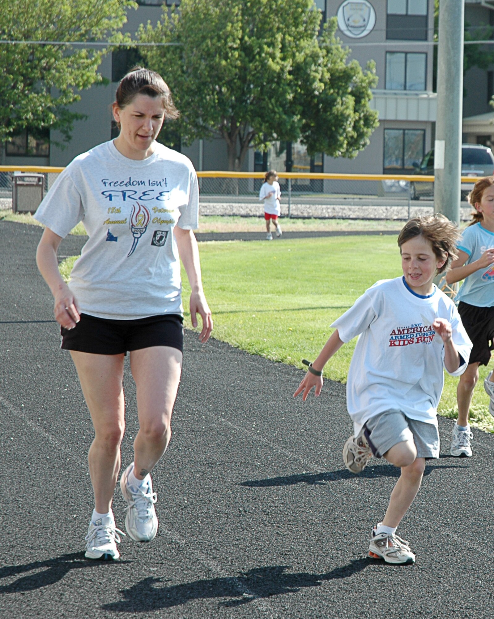 MOUNTAIN HOME AIR FORCE BASE, Idaho -- First Lt. Rachel Hindelang, 726th Air Control Squadron, runs with her son, Jacob, during the America’s Armed Forces Kids Run here May 19. Held in conjunction with Armed Forces Day, the run is geared for children ages five and up to promote a more active lifestyle, according to Lissa Hall, Boys and Girls Club coordinator with the youth center here. U.S. Air Force photo/Airman Samantha S. DeVries