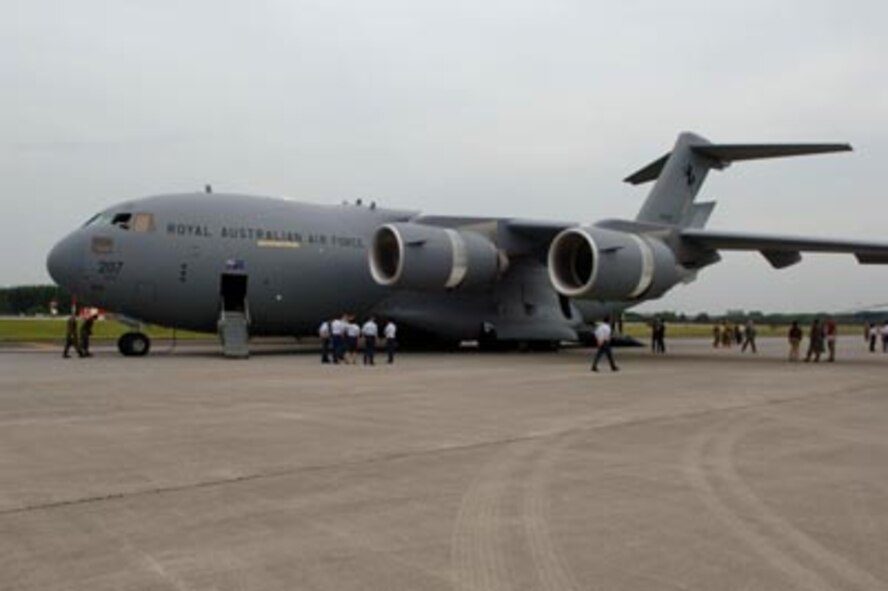 YOKOTA AIR BASE, Japan--Personnel from the United Stated Air Force, Royal Australian Air Force and Japan Air Self Defense Force discuss air mobility operations behind a RAAF C-17. The three countries took part in the Pacific Global Air Mobility Seminar which identified air mobility roles in the Pacific Theater.