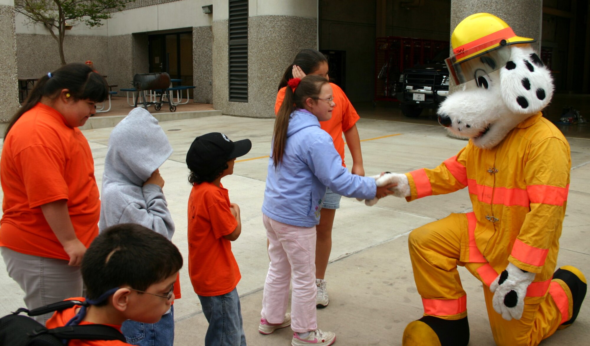 LAUGHLIN AIR FORCE BASE, Texas -- "Sparky the Fire Dog" intrigues a group of special-needs children form Del Rio May 18 when they visited the 47th Flying Training Wing fire department to learn more about the hard work firefighters do every day. (U.S. Air Force photo by Airman Sara Csurilla)

