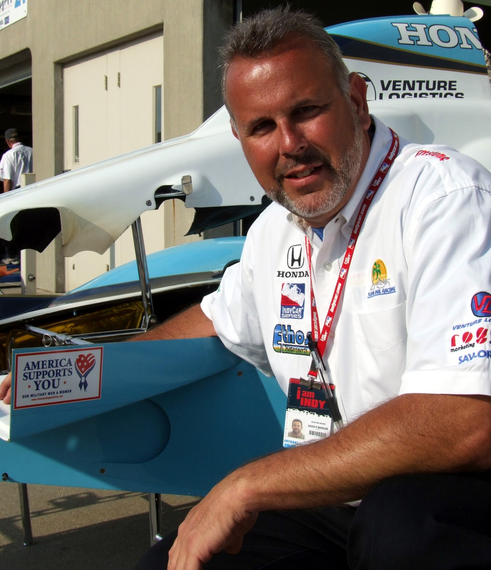 David Morgan, team manager for Playa del Racing, shows off the "America Supports You" decal affixed to the nacelle of one of his team's race cars in "Gasoline Alley" at Indianapolis Motor Speedway on May 20.  (Department of Defense photo/Gerry J. Gilmore)
