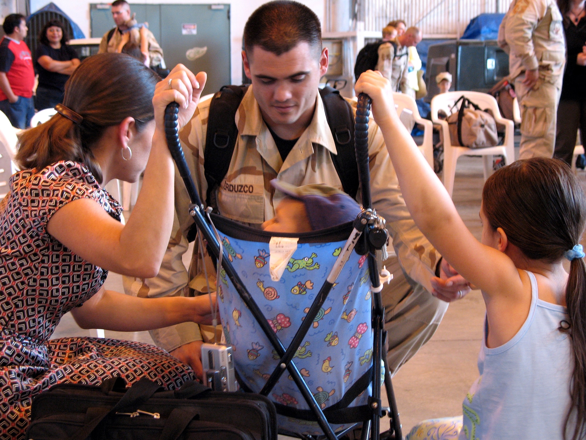 Master Sgt. Richard Verduzco reunites with his family after not seeing them for nine months May 18 at Aviano Air Base, Italy. Sergeant Verduzco is assigned to the 31st Civil Engineer Fire Protection Flight. (U.S. Air Force photo/Staff Sgt. Tara O'Brien)
