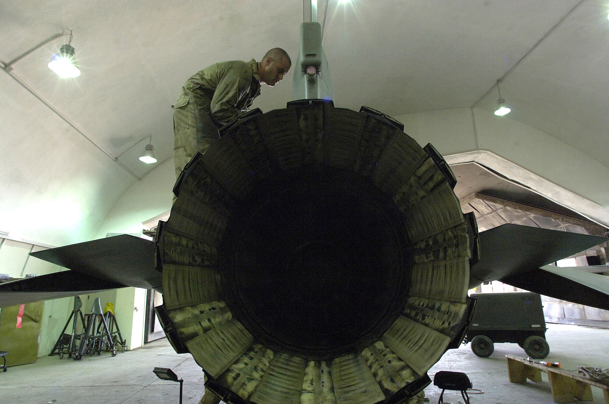 Staff Sgt. Justin Johnson removes panels from an F-16 Fighting Falcon during a routine phase inspection at Balad Air Base, Iraq, recently.  Sergeant Johnson is assigned to the 332nd Expeditionary Maintenance Squadron.  (U.S. Air Force photo/Airman 1st Class Nathan Doza)