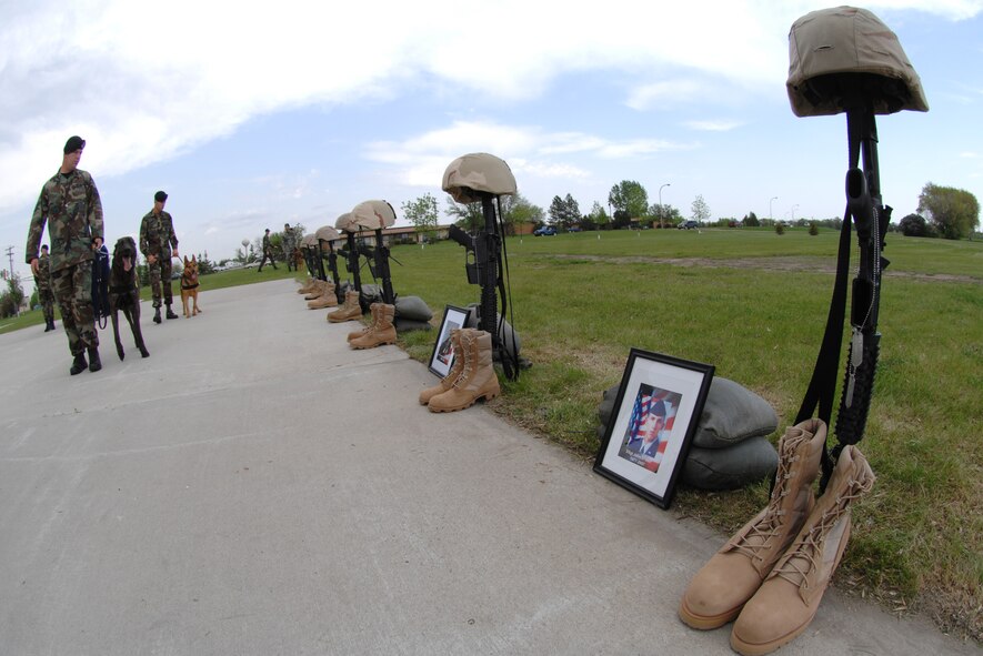 MINOT AIR FORCE BASE, N.D. – Memorials of Air Force security forces members and Office of Special Investigations agents who have died in Operation Iraqi Freedom line the base flag pole pad during the annual National Police Week retreat ceremony here May 18. As part of the ceremony, the names of law-enforcement officers killed in the line of duty in North Dakota and the names of security-forces Airmen and OSI agents killed in OIF were read. (U.S. Air Force photo by Senior Airman Christopher Boitz)
