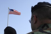 MINOT AIR FORCE BASE, N.D. – An Airman salutes the flag during the annual National Police Week retreat ceremony at the base flag pole here May 18. National Police Week was established by President John F. Kennedy in 1962 to recognize the service and sacrifice of the nation’s police officers. (U.S. Air Force photo by Senior Airman Christopher Boitz)