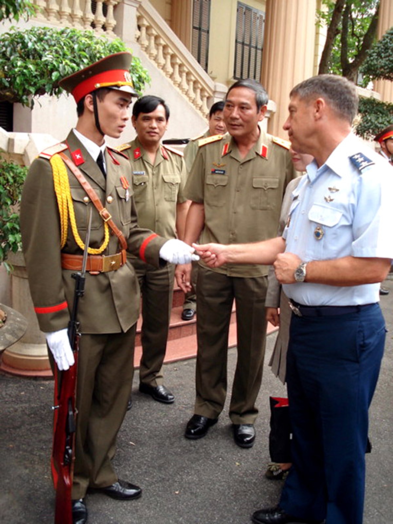 Lt. Gen. Dan Leaf presents a coin to a Vietnamese soldier.  General Leaf was in Vietnam recently to identify possible future military engagement activities.   He is U.S. Pacific Command deputy commander.  (U.S. Air Force photo)