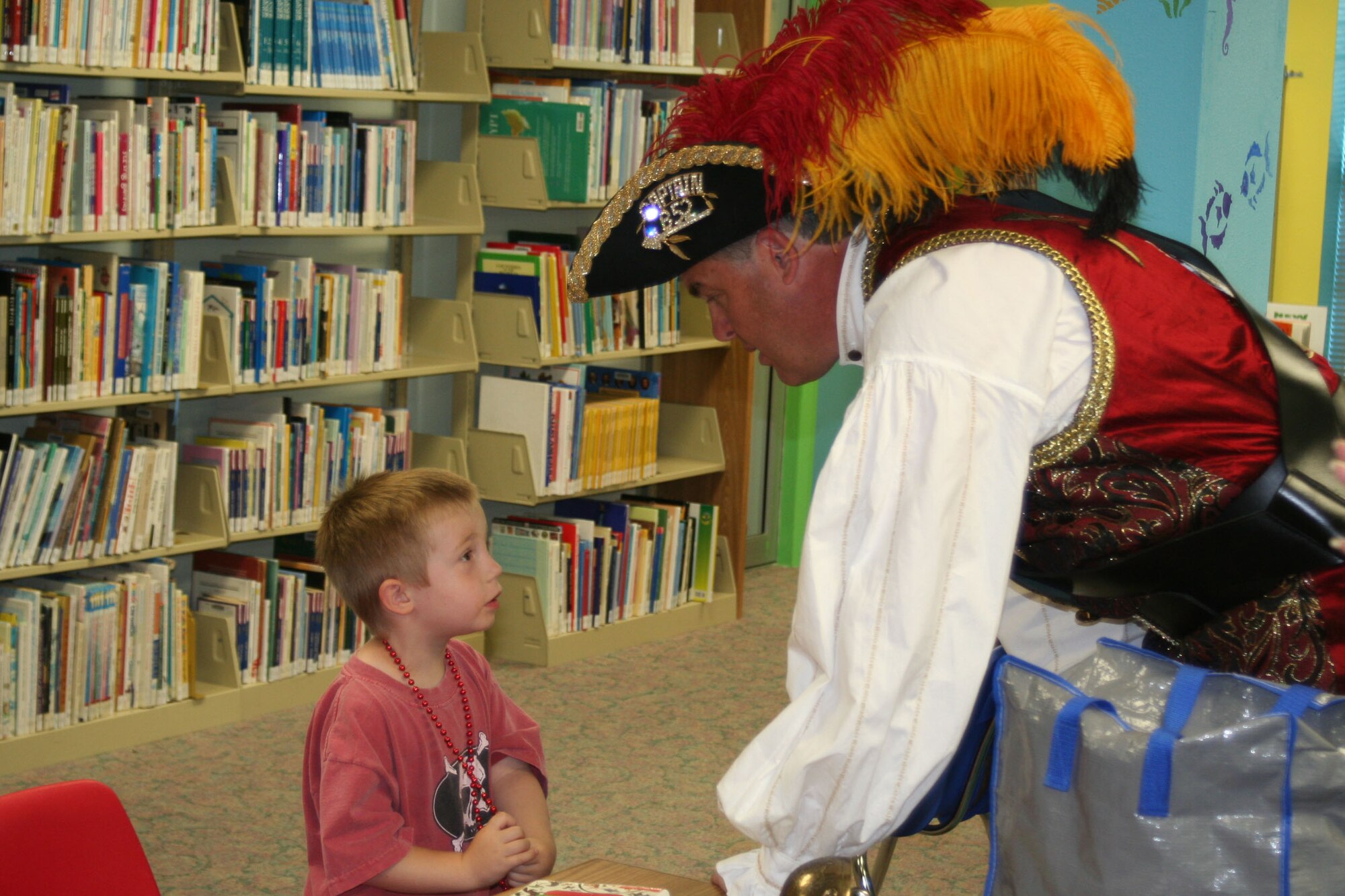 EGLIN AIR FORCE BASE, Fla. -- Billy Bowlegs Michael Gates visits with Alex Eastman at the library May 19. King Billy visited the library to kick off the summer reading program.  Children can earn prizes by completing reading activities from now until the program end July 19.