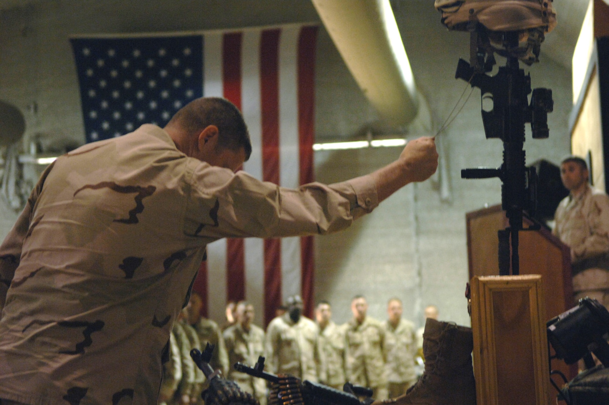 Brig. Gen. Robin Rand holds Staff Sgt. John T. Self's dog tags to show respect during Sergeant Self's May 18 memorial ceremony at the town hall at Balad Air Base, Iraq. Sergeant Self died during combat operations May 14 in the Baghdad area. (U.S. Air Force photo/Tech. Sgt. Alan Port) 
