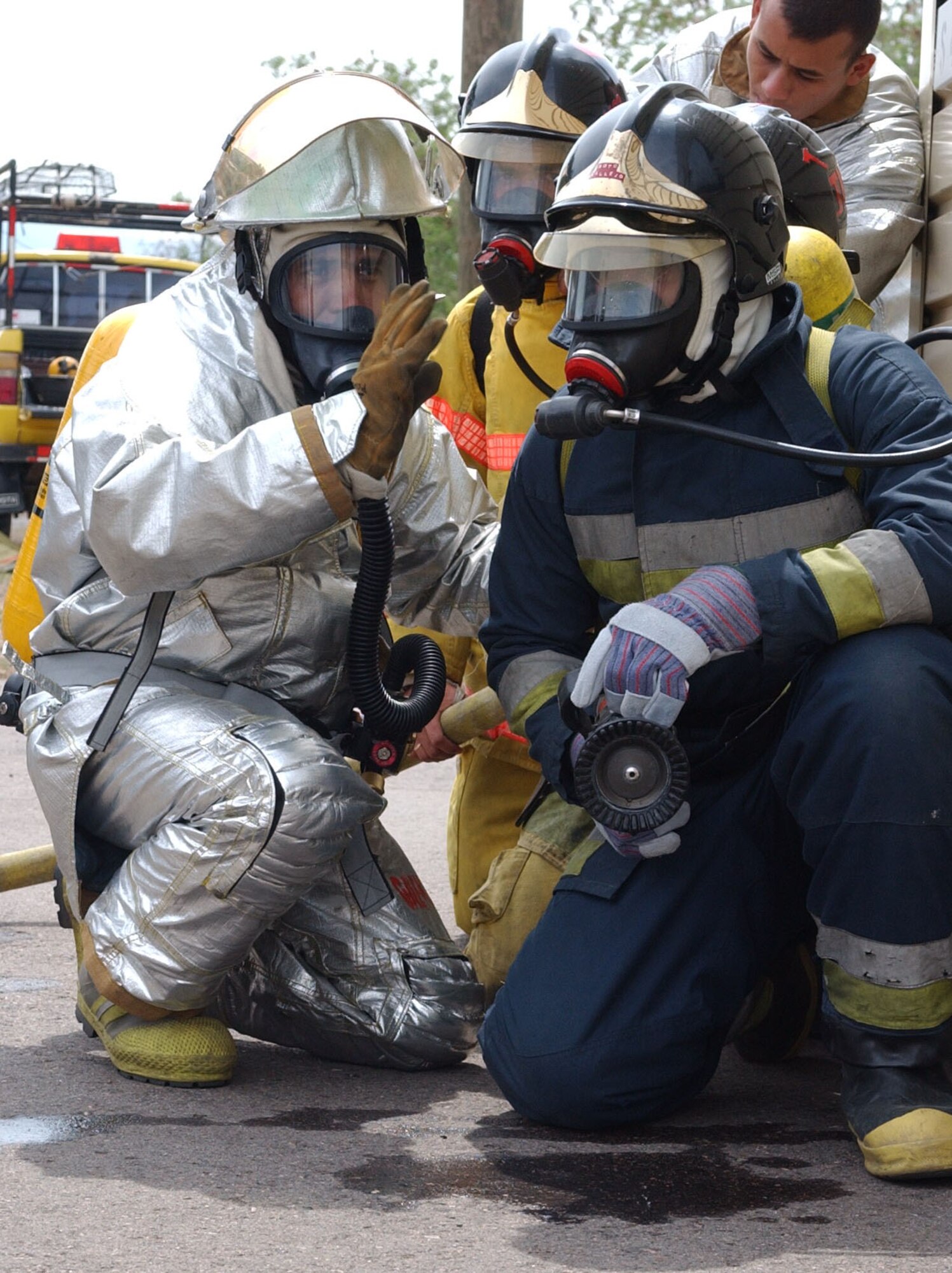 (Left), Mr. Herbert Gaekel, a Honduran fire inspector,  gives instructions to a Honduran firefighter prior to entering the burn building during a training exercisea at Soto Cano Air Base May 19, 2007. U.S. Air Force photo by Senior Airman Shaun Emery
