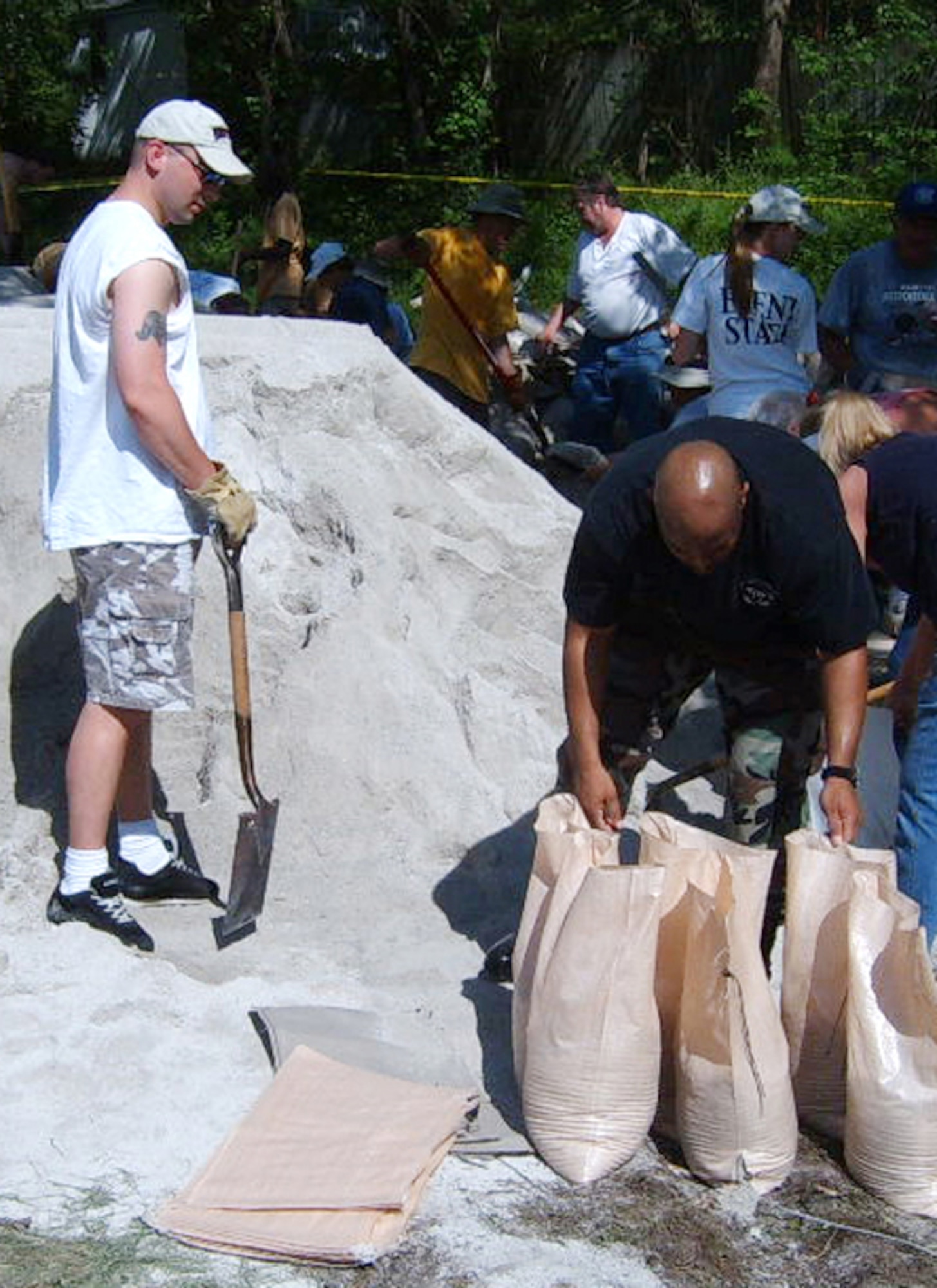 WHITEMAN AFB, Mo. – Tech. Sgt. Jeramie Hill and Staff Sgt. John Kowalczyk fill sandbags near Rocheport, Missouri to help build a levee to protect the town.  The sergeants were part of a group from 72d Test and Evaluation Squadron who volunteered to help the town after the area received as much as 8 inches of rain in a 24-hour period and forced local rivers to crest near record levels. (U.S. Air Force photo/Staff Sgt. Jeffrey Heying)
