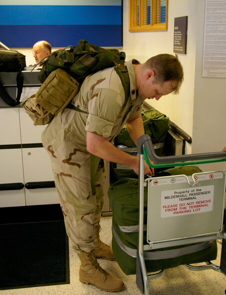 Maj. Jeff Lumm, 100th Logistics Readiness Squadron, checks his bags at the 727th Air Mobility Command at the RAF Mildenhall Passenger Terminal May 18. Major Lumm, and approximately 65 troops from RAF Lakenheath, were preparing to deploy to southwest Asia. Major Lumm, 100th LRS director of operations, will be working with coalition forces with the Multi National Forces Iraq on the logistics agreement which ensures coalition forces can use American and Air Forces services, and vice versa. (U.S. Air Force photo by Karen Abeyasekere)