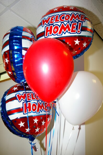 Families brought "Welcome Home" balloons for their friends and family members returning from southwest Asia, as they arrived home at the RAF Mildenhall Passenger Terminal May 19. (U.S. Air Force photo by Karen Abeyasekere)