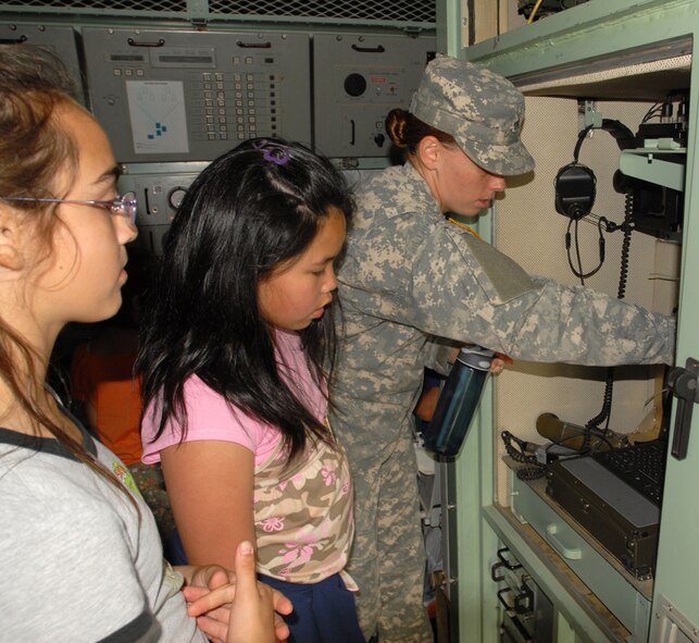 Sgt. Jessica Morales, 1-1 Air Defense Artillery Battalion, Kadena Air Base, Japan, shows a couple of Girl Scouts where a computer is located inside an engagement control station during a visit to the unit by Girl Scout Troops 414, 432, 433, and 435 May 15. The purpose of the visit was to show the girls the importance of the unit in protecting them against any danger from our enemies, and to show that there are plenty of good women role models in the services they can look up to.
(U.S. Air Force/Airman 1st Class Kasey Zickmund)