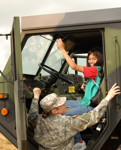 Sgt. Crystal Krug, 1-1 Air Defense Artillery Battalion, Kadena Air Base, Japan, lets Mei Knuth pull the horn on the radar set vehicle during a visit to the unit by Girl Scout Troops 414, 432, 433, and 435 May 15. The purpose of the visit was to show the girls the importance of the unit in protecting them against any danger from our enemies, and to show that there are plenty of good women role models in the services they can look up to.
(U.S. Air Force/Airman 1st Class Kasey Zickmund)