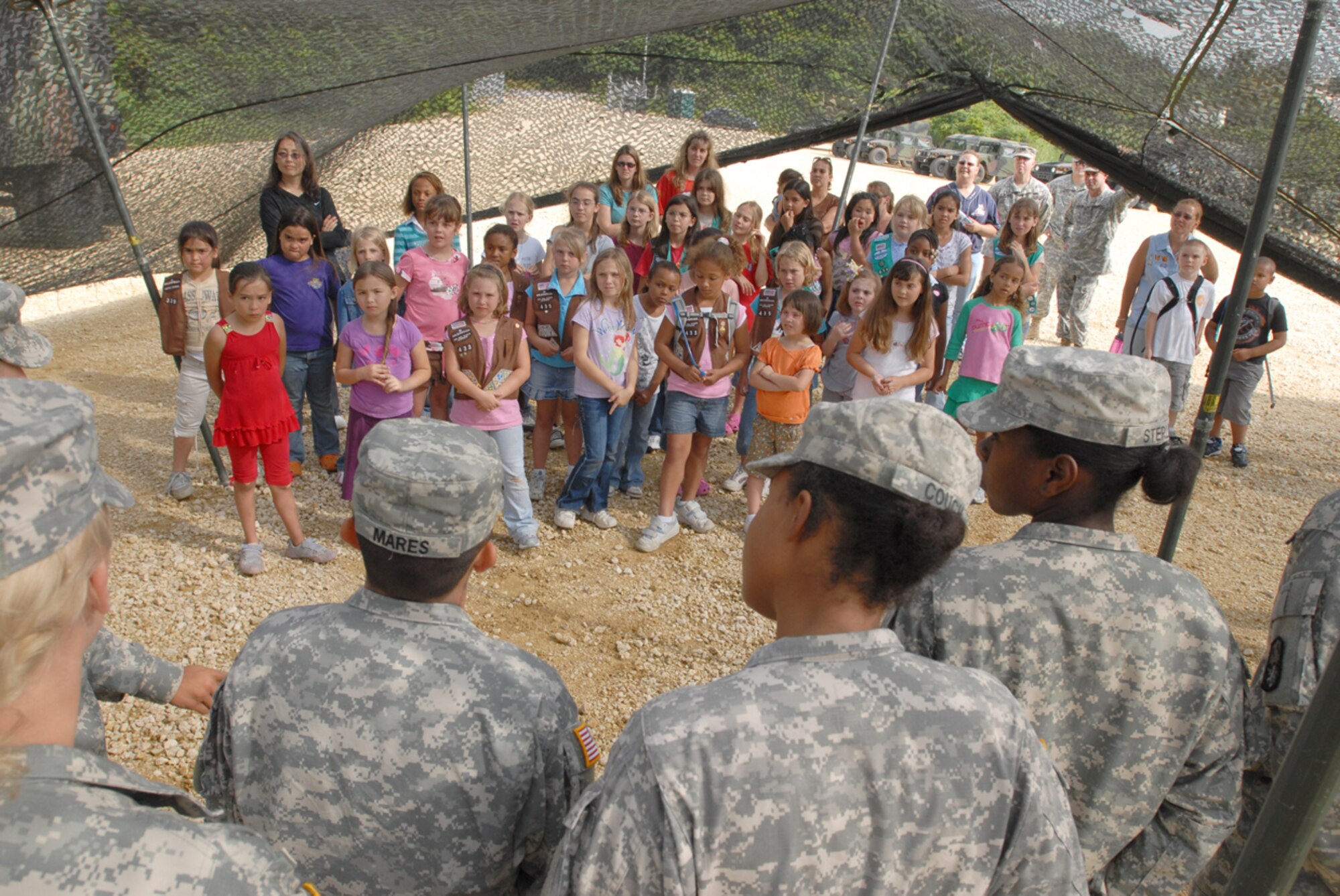 Girl Scout Troops 414, 432, 433, and 435 are introduced to women from the 1-1 Air Defense Artillery Battalion at Kadena Air Base, Japan, May 15. The women in turn showed the girls the different pieces of artillery equipment each one works on. The purpose of the visit was to show the girls the importance of the unit in protecting them against any danger from our enemies, and to show that there are plenty of good women role models in the services they can look up to.
(U.S. Air Force/Airman 1st Class Kasey Zickmund)
