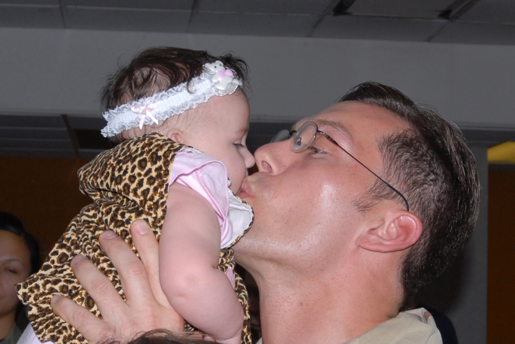 Capt. James Flagg, 18th Munitions Squadron, kisses his daughter after returning from a deployment during the AEF 5/6 cycle. Captain Flagg was one of 55 people who returned to Kadena Air Base, Japan, May 15.
(U.S. Air Force/Airman 1st Class Kasey Zickmund)