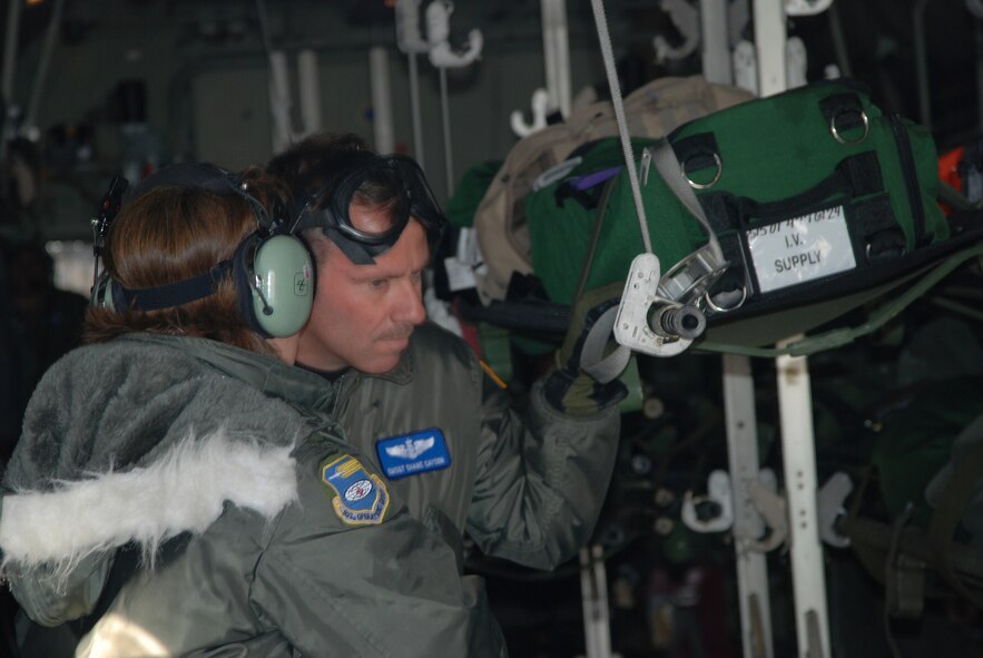 932nd Airlift Wing members get equipment ready for takoff on a visiting C-130 during an Aeromedical Evacuation excercise at Scott Air Force Base.  Photo/ Capt. Stan Paregien