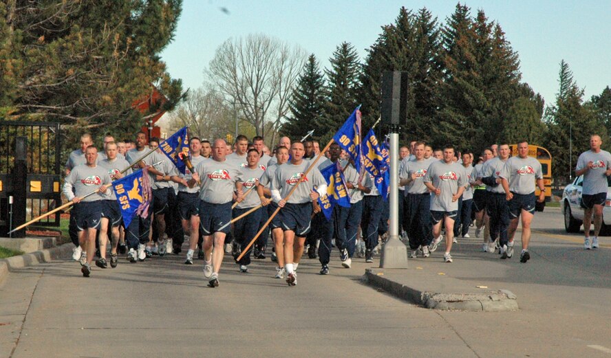 Warren security forces members run the final stretch of the torch run before passing the Flame of Hope to the Cheyenne Police Department May 10.