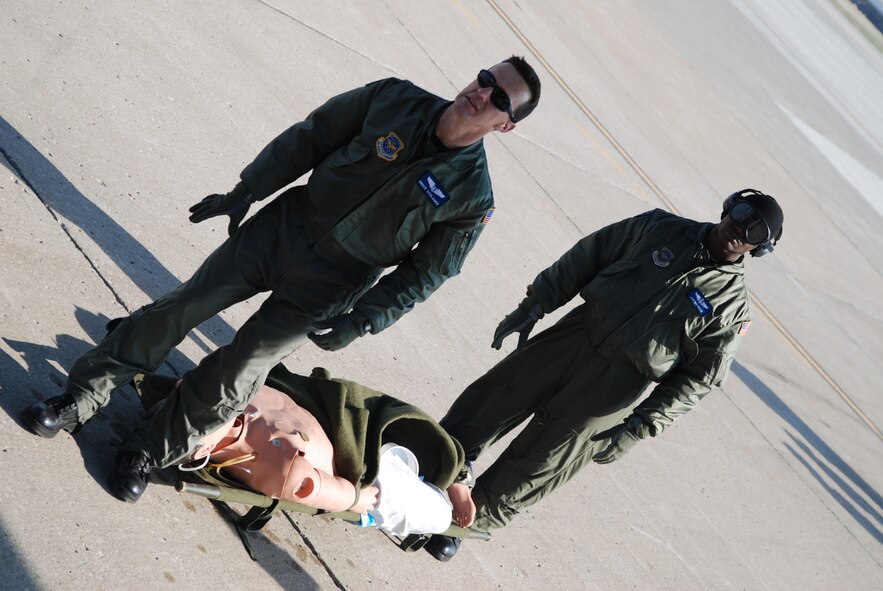 932nd Airlift Wing members check out a "SIM MAN" electronic patient before loading him on a visiting C-130 during an Aeromedical Evacuation excercise.