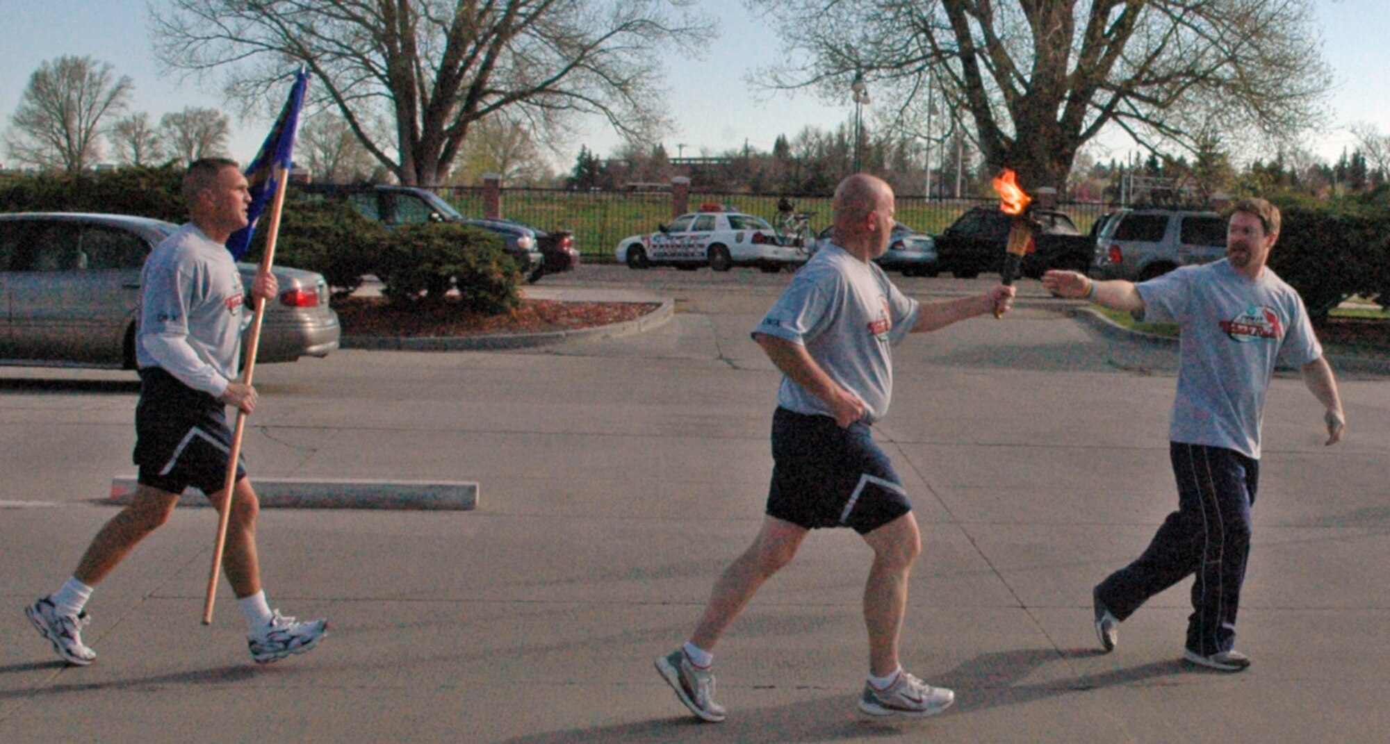 Tech. Sgt. Joe Cason, 90th Missile Security Forces Squadron, passes the Flame of Hope to a member of the Cheyenne Police Department May 10. More than 300 security forces members participated in the torch run. The torch's next stop: the Wyoming Special Olympic games in Laramie, Wyo. (Photos by Airman Alex Martinez).