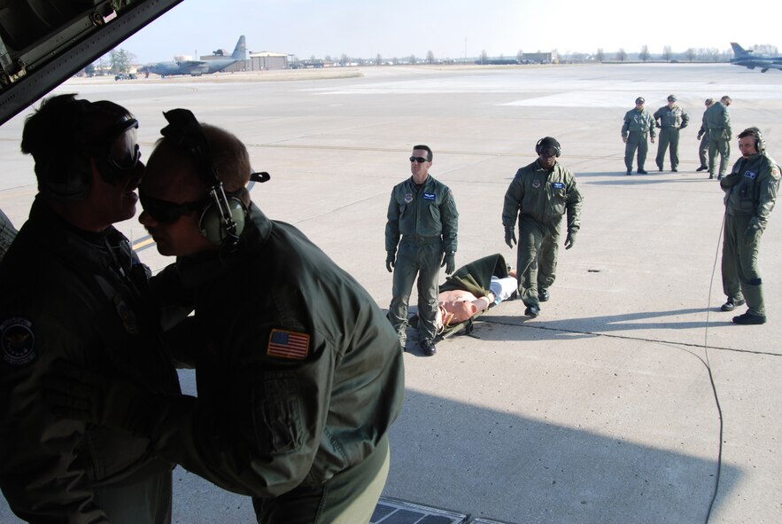 Members of the 932nd Aeromedical 
Evacuation Squadron recently accomplished 
training in the air by heading southeast to Nashville, Tenn. 

Airlift was provided courtesy of a 
C-130 from the 908th Airlift Wing at 
Maxwell, Ala. 

The purpose was to help them get 
additional training in their skill areas and 
to show civilian first responders some 
techniques that were used during Hurricane 
Katrina relief, which many of the 
Reservists were involved in. 

Approximately 100 responders met 
out at the Nashville airport with the AES 
coordinators to see and feel the action. 

Many of the civilians took their turns lifting 
litters to understand how heavy they 
actually are, and to see how long it might 
take to load and unload an aircraft like 
the C-130. 

"It was great because we could share our 
experiences, so in the future we can all 
function as a team to assist the public in a 
time of need," said MSgt. Shane Cayson, 
aeromedical technician.  Photo/ Capt. Stan Paregien