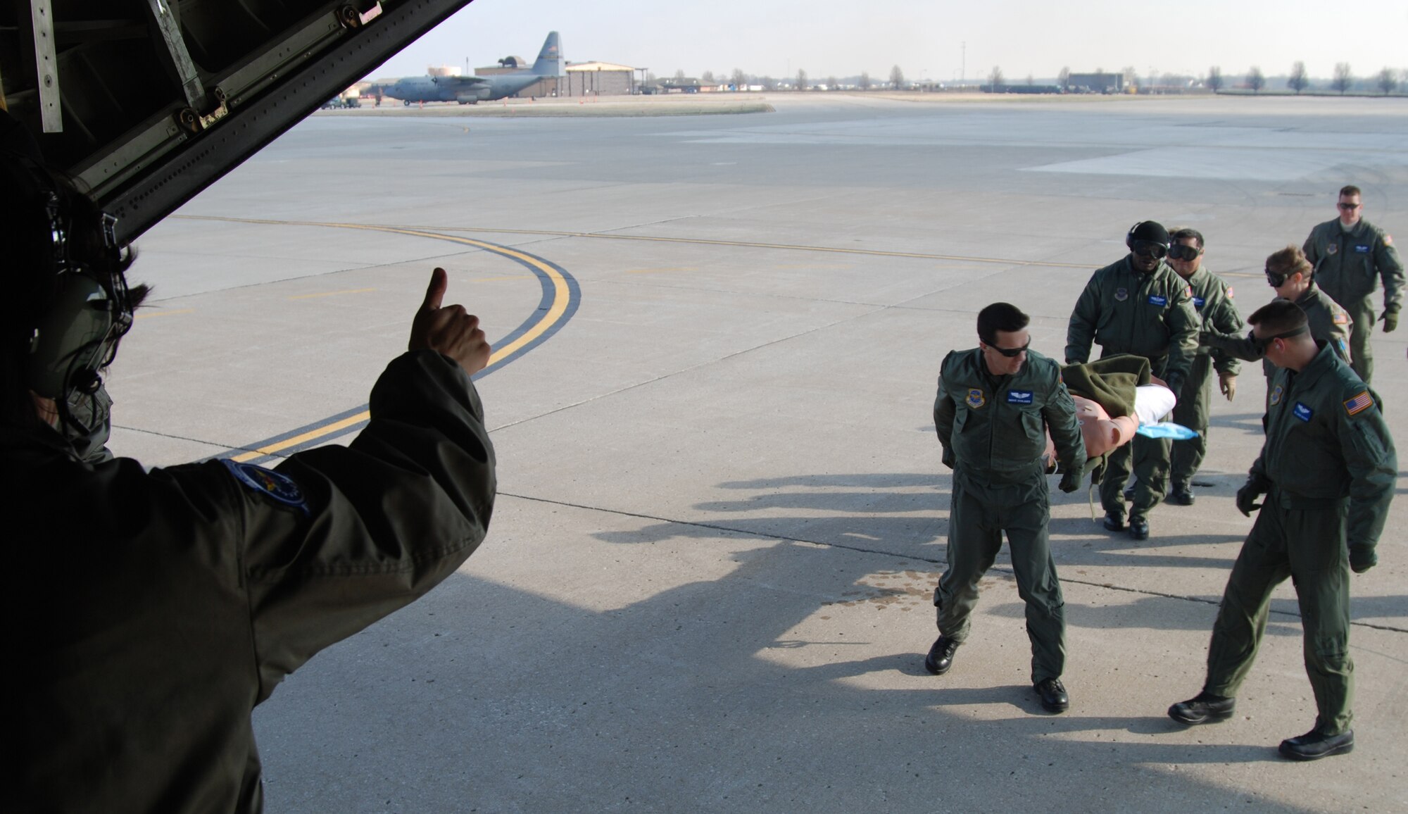 Thumbs up!  Members of the 932nd Aeromedical 
Evacuation Squadron recently accomplished 
training in the air by heading southeast to Nashville, Tenn. 

Airlift was provided courtesy of a 
C-130 from the 908th Airlift Wing at 
Maxwell, Ala. 

The purpose was to help them get 
additional training in their skill areas and 
to show civilian first responders some 
techniques that were used during Hurricane 
Katrina relief, which many of the 
Reservists were involved in. 

Approximately 100 responders met 
out at the Nashville airport with the AES 
coordinators to see and feel the action. 

Many of the civilians took their turns lifting 
litters to understand how heavy they 
actually are, and to see how long it might 
take to load and unload an aircraft like 
the C-130. 

"We couldn't have asked for a better 
weekend of training and the civilians 
left with an improved understanding of 
what we do, and how they can help during 
disasters," said Lt. Col. Mary Jo 
Abernethy. 

"It was great because we could share our 
experiences, so in the future we can all 
function as a team to assist the public in a 
time of need," said MSgt. Shane Cayson, 
aeromedical technician.