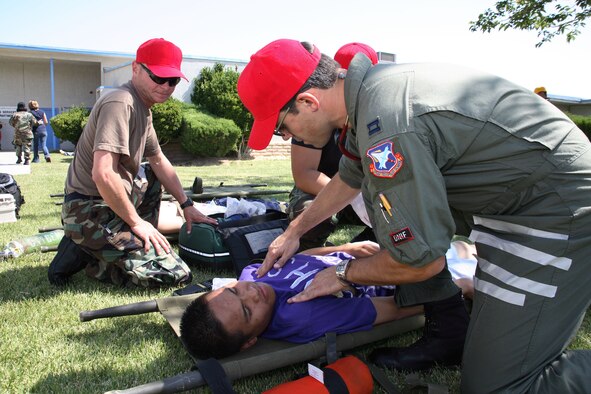 Edwards Airmen perform self aid, buddy care to an "injured victim" during an earthquake exercise here May 16. (Photo by Jet Fabara)