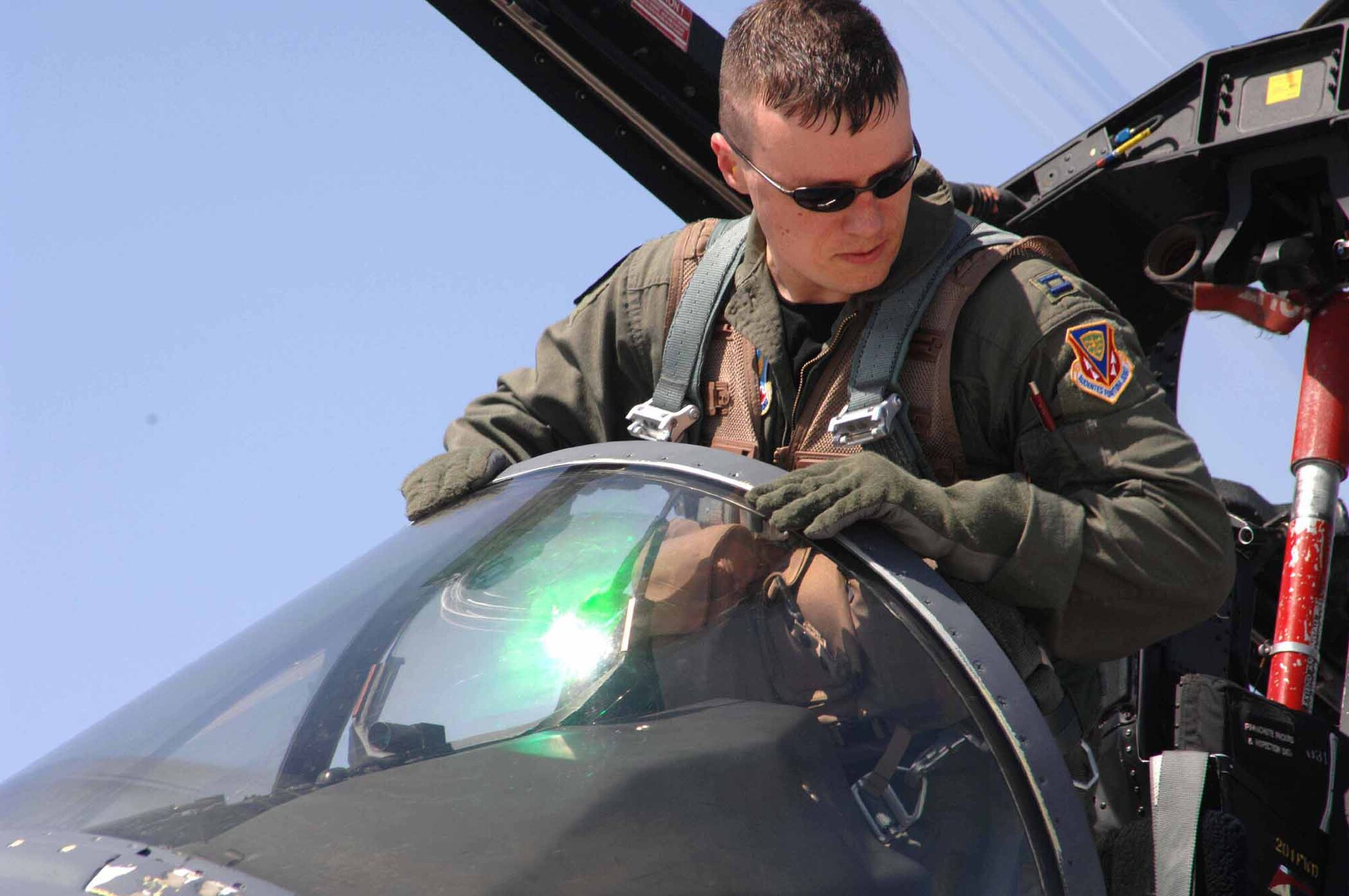 NELLIS AIR FORCE BASE, Nev. -- Capt. Dominic Chiapusio, an F-15E Strike Eagle pilot with the 389th Fighter Squadron at Mountain Home Air Force Base, climbs out of the cockpit after a training mission at Nellis Air Force Base, Nev., May 17. Aircrews and maintenance troops from the 389th and 391st Fighter Squadrons and 389th and 391st AMUs at Mountain Home Air Force Base traveled to Nellis earlier this month to complete a week-long weapons instructor course. The temporary duty assignment became the first for the 389th FS since becoming an F-15E Strike Eagle squadron in March. (U.S Air Force photo/Senior Airman Larry E. Reid Jr.)