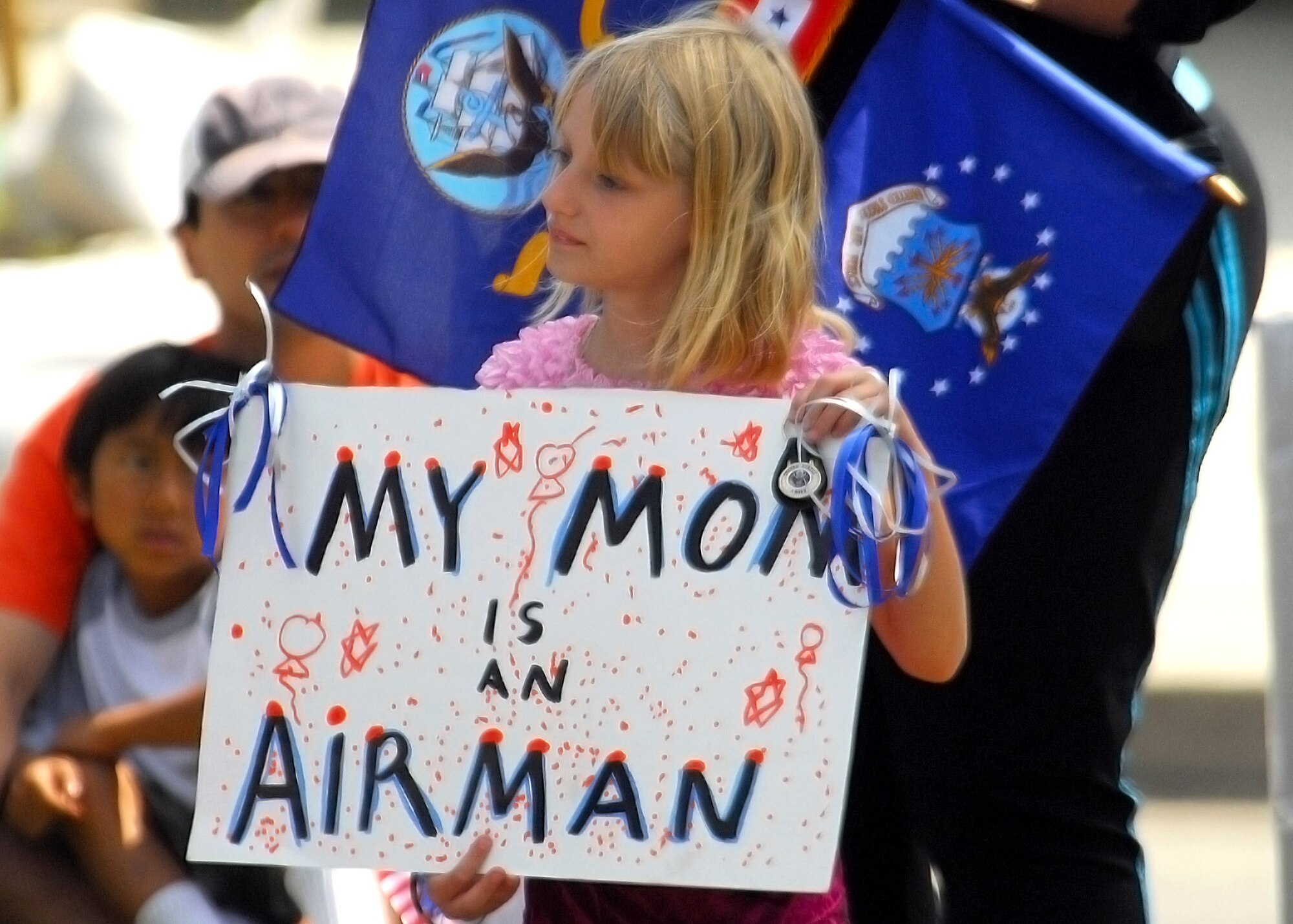 A young girl shows support for her mother May 19 during the 48th Annual Armed Forces Day parade in Torrance, Calif. (U.S. Air Force photo/Tech. Sgt. Raheem Moore)