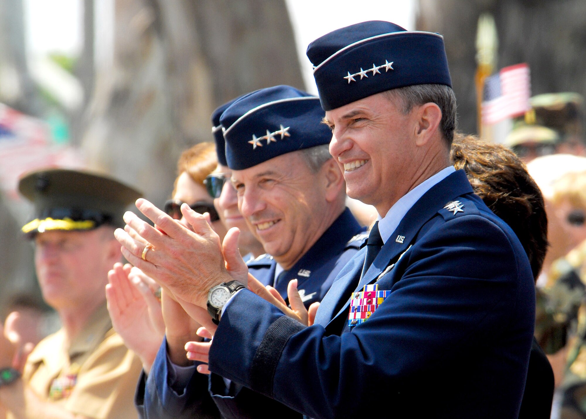 Gen. Kevin P. Chilton (right), commander of Air Force Space Command, and Lt. Gen. Michael Hamel, commander of the Space and Missile Systems Center at Los Angeles Air Force Base, Calif., show their enjoyment during the 48th Annual Armed Forces Day parade May 19 in Torrance, Calif.  General Chilton was the grand marshal for the parade.  (U.S. Air Force photo/Tech. Sgt. Raheem Moore)