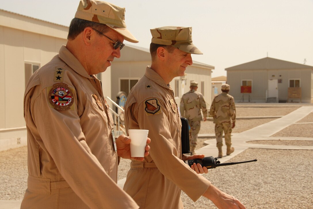 Lt. Gen. David A. Deptula (left) walks with Brig. Gen. Charles K. Shugg during his visit down range. The general discussed how a combined arms campaign with integrated airpower is the only way to build success in both theaters. General Deptula is the deputy chief of staff for intelligence, surveillance and reconnaissance. General Shugg is the 379th Air Expeditionary Wing commander. (U.S. Air Force photo)