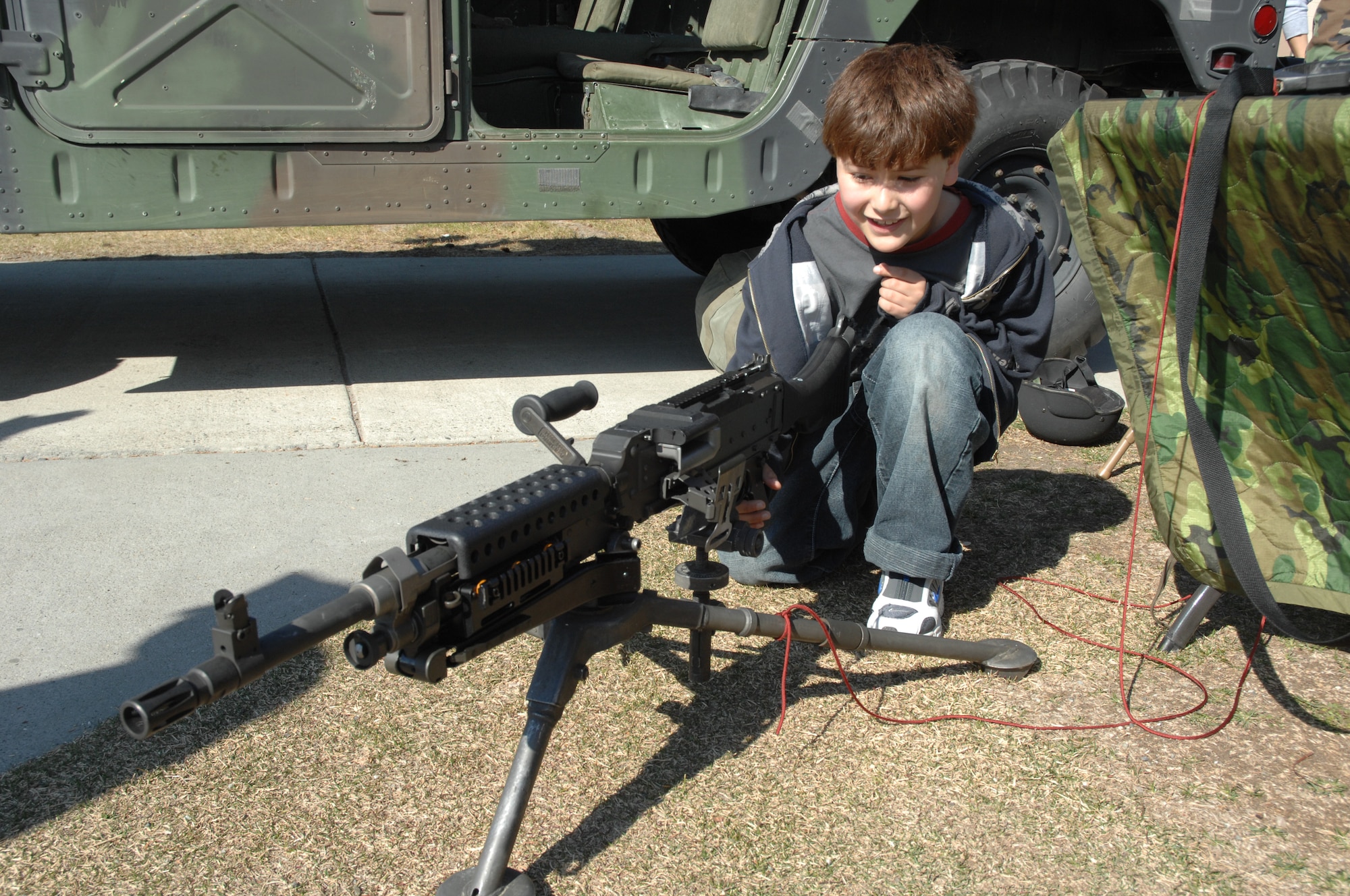EIELSON AIR FORCE BASE, Alaska -- Michael Alverez, son of Staff Sgt. Matt Gogh, the 354th Medical Group, looks over the components of an M-249 automatic rifle during Police Week May 19 here at Eielson AFB, AK. Police Week is an annual event hosted by the 354th Security Forces Squadron in honor of National Police Week, among many of the activities occurring during the week is a weapons display to promote weapons safety to the general public. (U.S. Air Force photo by Staff Sgt. Tia Schroeder)


