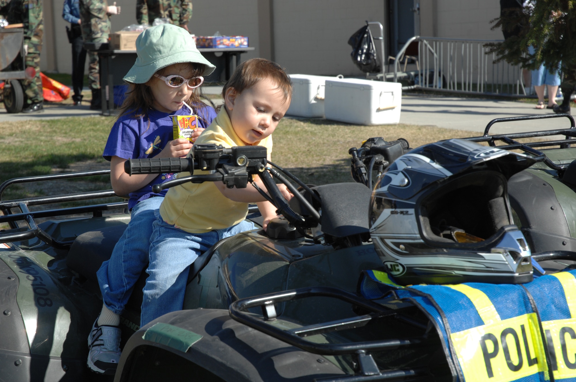EIELSON AIR FORCE BASE, Alaska -- Jordan and Morgan Ossman, daughters of Capt. Derrick Ossman, 354th Security Forces Squadron, check out the components of an all-terrain vehicle used by the 354th Security Forces Squadron during Police Week May 19 here at Eielson AFB, AK. Police Week is an annual event hosted by the 354th SFS in honor of National Police Week. (U.S. Air Force photo by Staff Sgt. Tia Schroeder)
