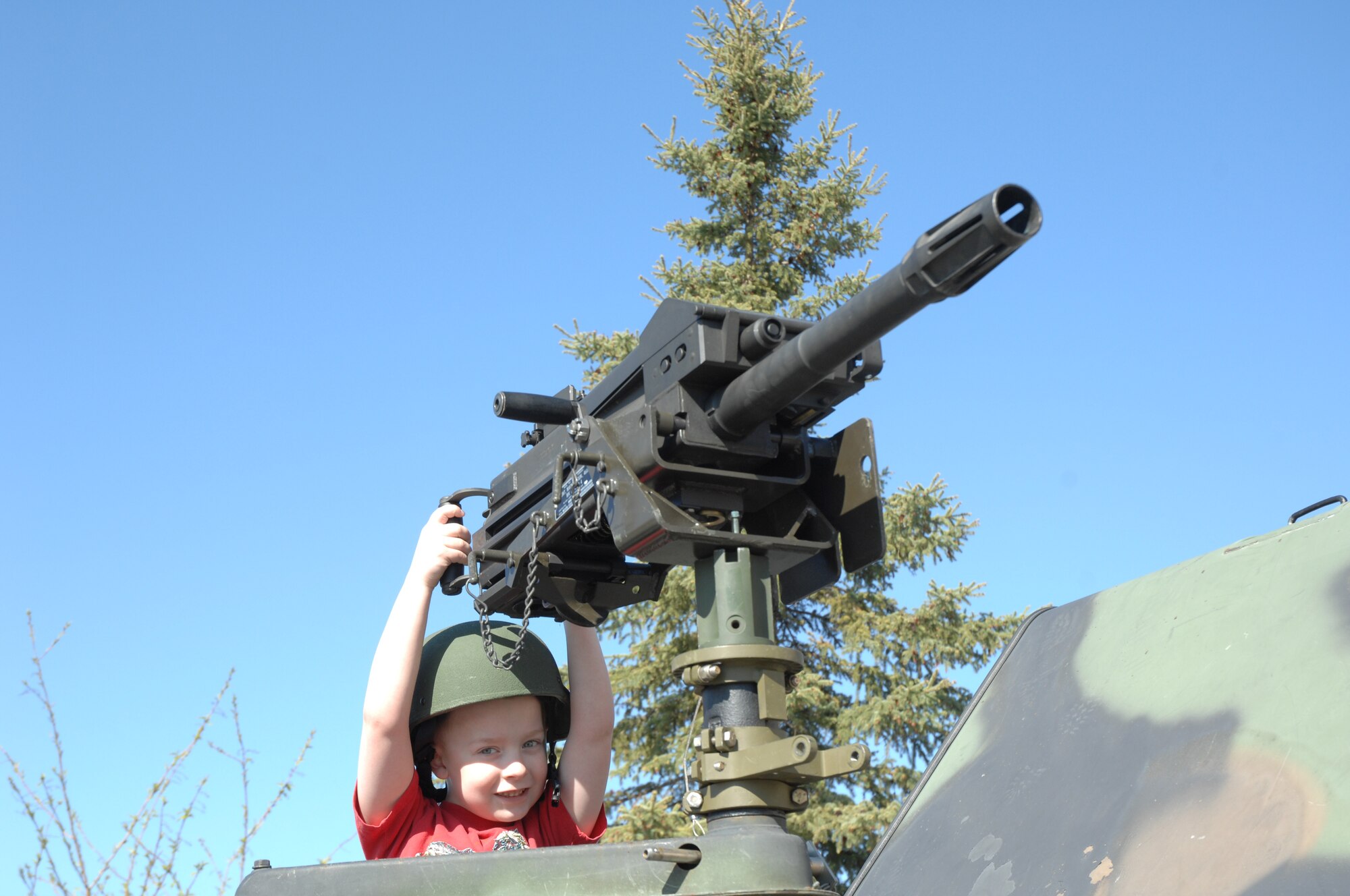 Phillip Dachel, son of Tech. Sgt. Jon Dachel, simulates the firing of a Mark-19 automatic grenade launcher during Police Week May 19, here at Eielson AFB, AK. Police Week is an annual event hosted by the 354th Security Forces Squadron in honor of National Police Week. Among many of the activities occurring during the week is a weapons display to promote weapons safety to the general public.   (U.S. Air Force photo by Staff Sgt. Tia Schroeder)

